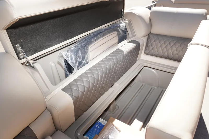 Slide: The Image of 2024 Sun Tracker Party Barge 20 DLX storage compartment with quilted seating and ample space. - 6