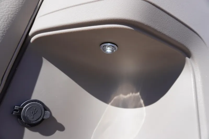 Slide: The Image of 2024 Sun Tracker Party Barge 20 DLX interior detail with USB port and light. - 9