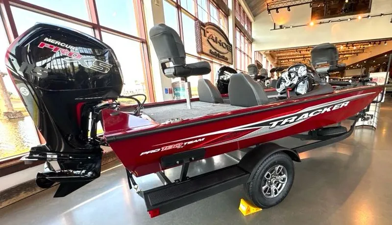 Slide: The Image of 2024 Tracker Pro Team 190 TX boat displayed indoors, featuring a sleek design and powerful engine. - 3