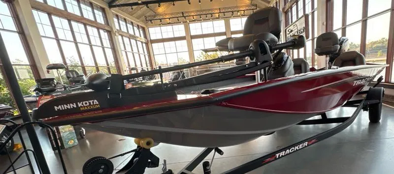 Slide: The Image of 2024 Tracker Pro Team 190 TX boat displayed indoors with Minn Kota motor. - 4