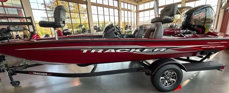 Slide: The Image of 2024 Tracker Pro Team 190 TX boat in showroom, side view, red color. - 5
