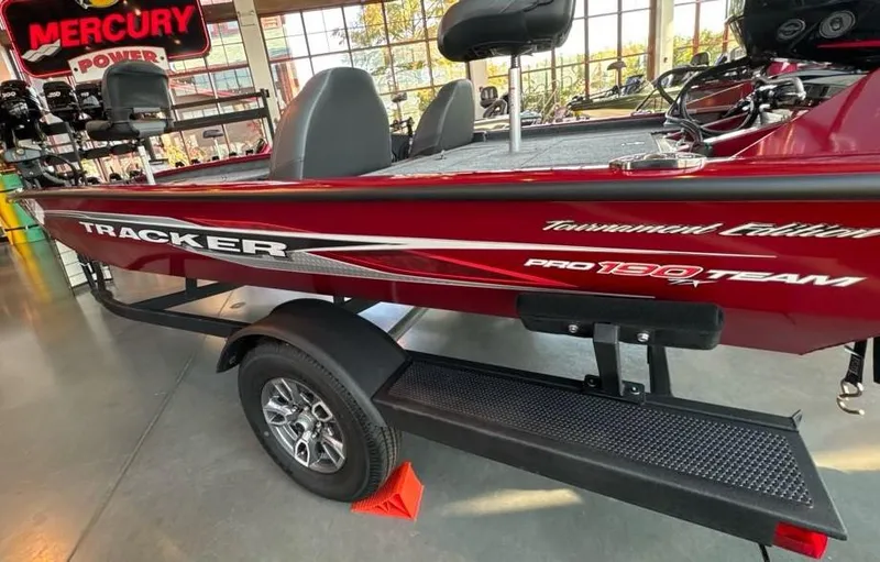 Slide: The Image of 2024 Tracker Pro Team 190 TX boat in showroom, red color, on trailer. - 6