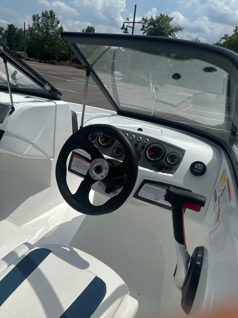 Slide: The Image of 2024 Tahoe 185 S boat interior with steering wheel and dashboard. - 7