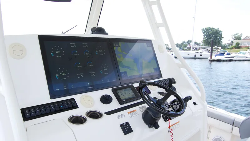 Slide: The Image of 2019 Regulator 41 boat dashboard with dual screens and steering wheel. - 14