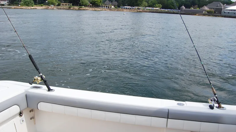 Slide: The Image of 2019 Regulator 41 boat with fishing rods on a calm water body. - 18