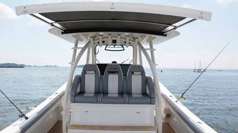 Slide: The Image of 2019 Regulator 41 boat interior with seating and fishing rods. - 21