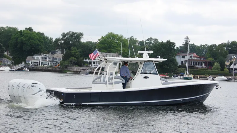 Slide: The Image of 2019 Regulator 41 boat cruising on a lake with houses in the background. - 24