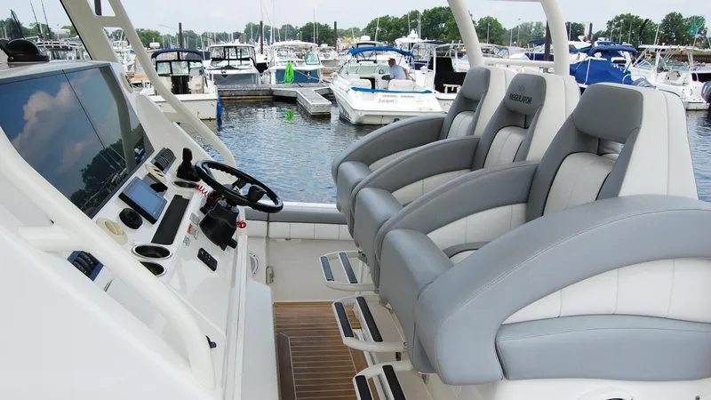 Slide: The Image of 2019 Regulator 41 boat cockpit with luxurious seating and advanced navigation controls. - 32