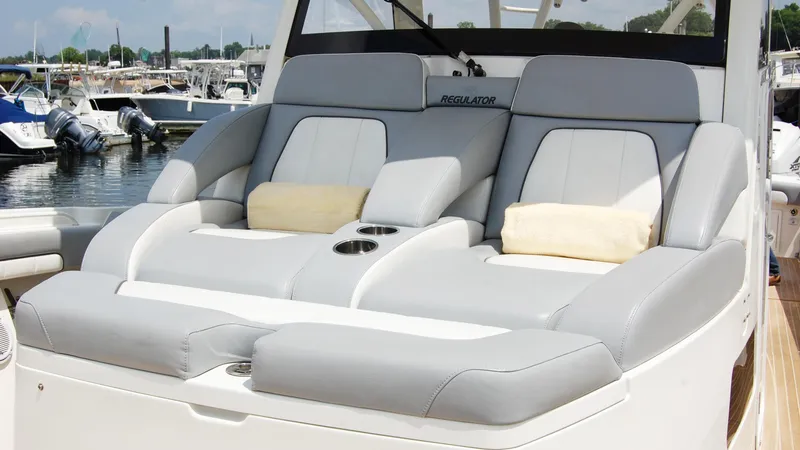 Slide: The Image of 2019 Regulator 41 boat with luxurious seating at a marina. - 37
