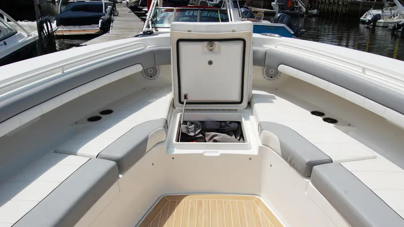 Slide: The Image of 2019 Regulator 41 boat bow seating area with open storage compartment. - 39