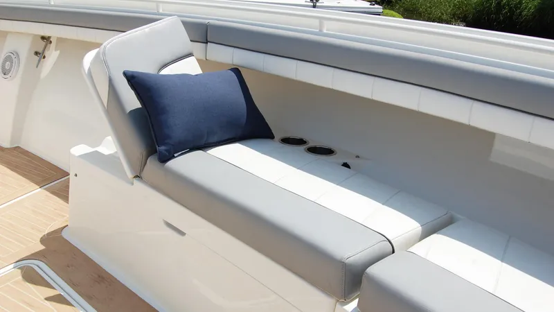 Slide: The Image of 2019 Regulator 41 boat with cushioned seating and navy blue pillow. - 41