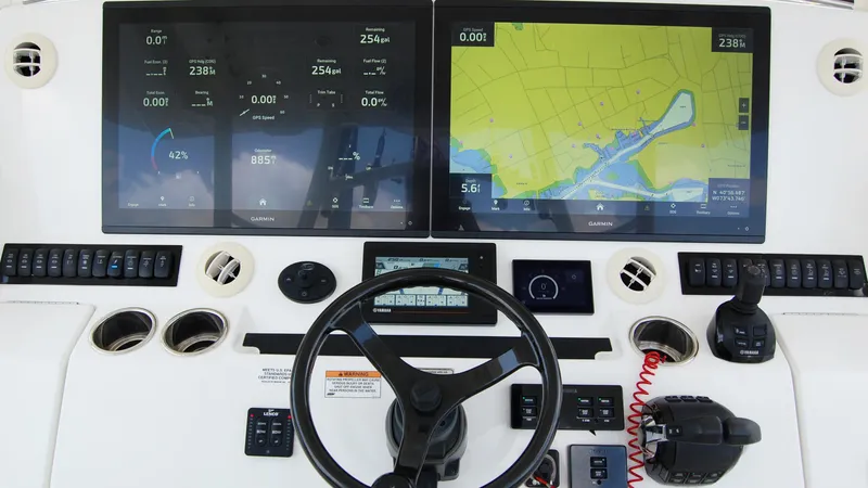Slide: The Image of 2019 Regulator 41 boat dashboard with dual Garmin displays and navigation controls. - 46