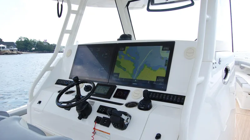 Slide: The Image of 2019 Regulator 41 boat dashboard with navigation screens and controls. - 6