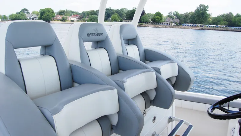 Slide: The Image of 2019 Regulator 41 boat with luxurious seating on a calm lake. - 7