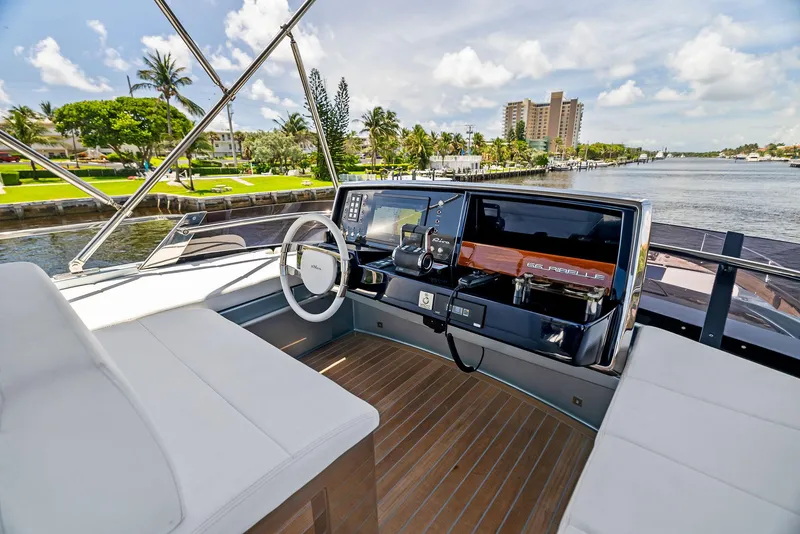 Slide: The Image of Cockpit view of 2020 Riva 66' Ribelle yacht with waterfront background. - 15
