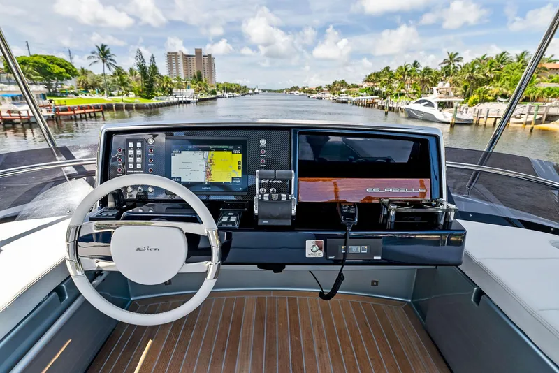 Slide: The Image of Cockpit view of a 2020 Riva 66' Ribelle yacht with advanced navigation systems. - 16
