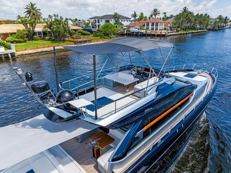 Slide: The Image of 2020 Riva 66' Ribelle luxury yacht cruising near waterfront homes. - 4