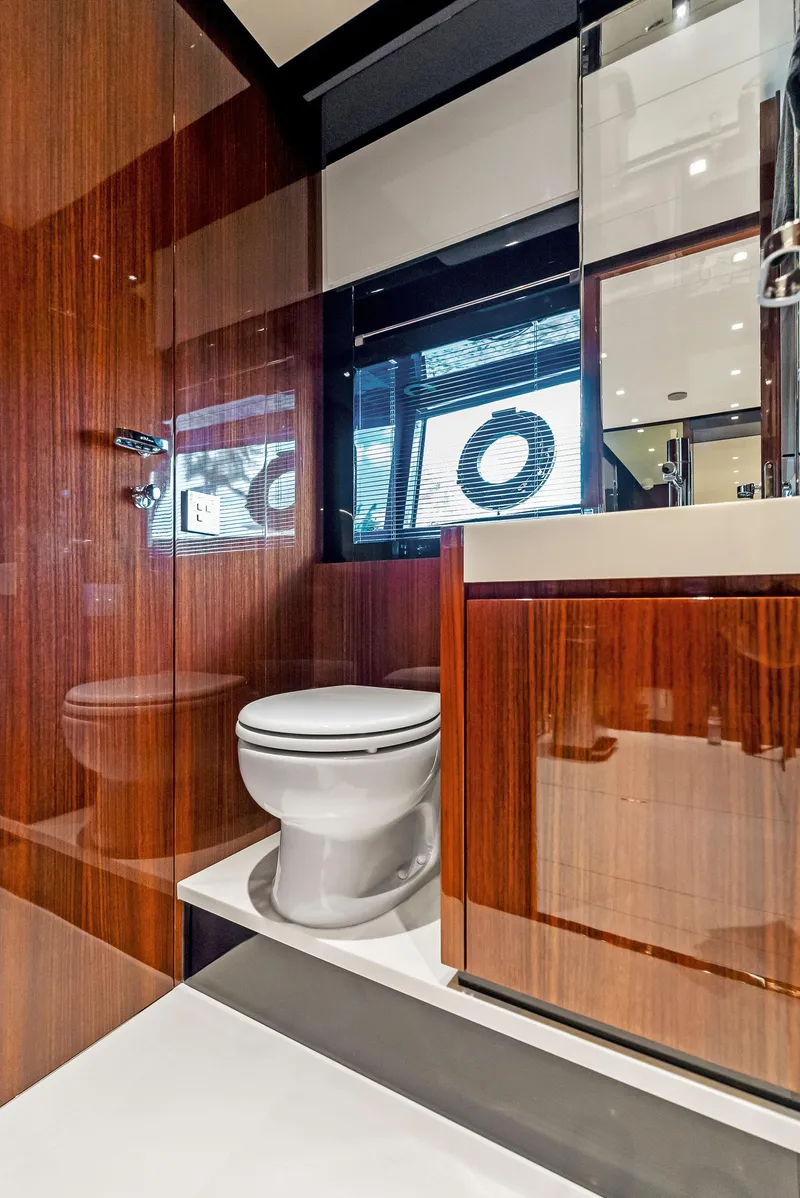 Slide: The Image of Luxurious bathroom on the 2020 Riva 66' Ribelle yacht with modern wood finishes. - 45