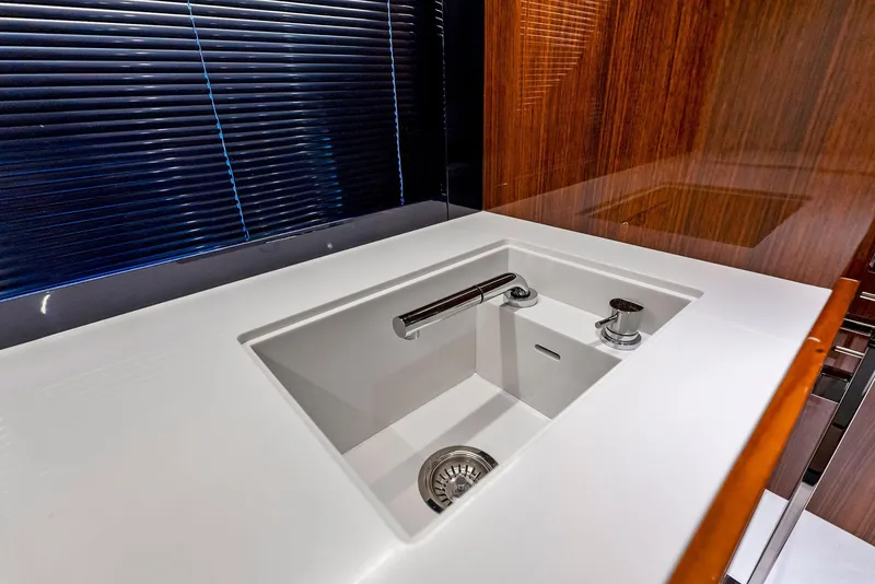 Slide: The Image of Modern kitchen sink in 2020 Riva 66' Ribelle yacht with sleek design and wooden accents. - 48