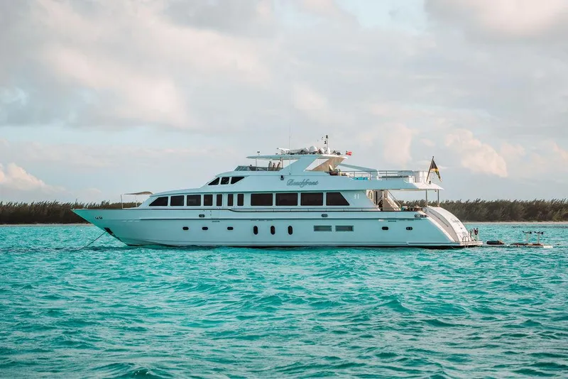 Slide: The Image of 2006 Hargrave Motor Yacht cruising on turquoise waters under a partly cloudy sky. - 1