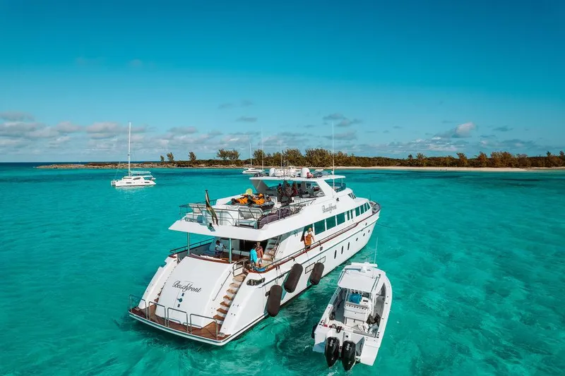Slide: The Image of 2006 Hargrave Motor Yacht anchored in clear turquoise waters near a tropical island. - 10