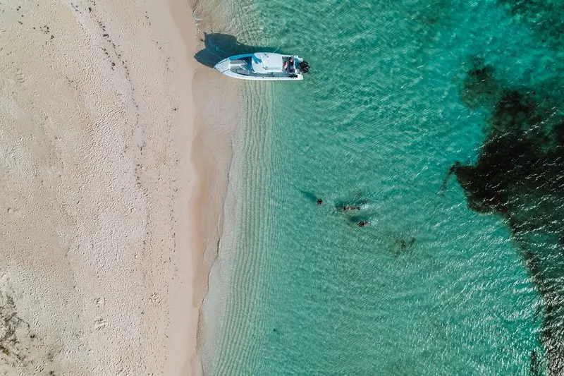 Slide: The Image of Aerial view of a 2006 Hargrave Motor Yacht anchored on a sandy beach. - 15