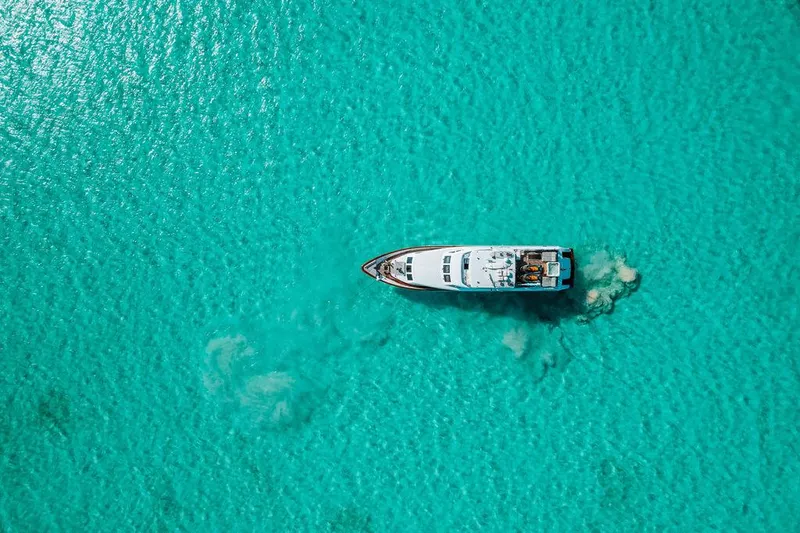 Slide: The Image of Aerial view of a 2006 Hargrave Motor Yacht cruising in clear turquoise waters. - 18