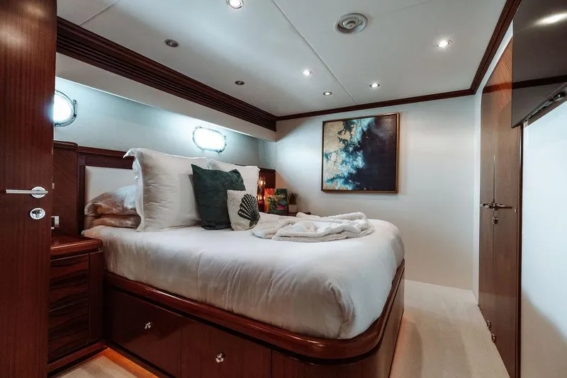 Slide: The Image of Luxurious bedroom on a 2006 Hargrave Motor Yacht with modern decor and cozy bedding. - 25