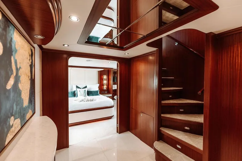 Slide: The Image of Luxurious interior of a 2006 Hargrave Motor Yacht with elegant wood finishes and a cozy bedroom. - 27