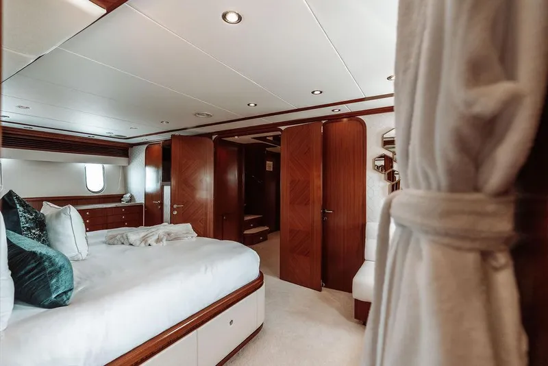 Slide: The Image of Luxurious bedroom interior of a 2006 Hargrave Motor Yacht with wooden accents. - 38