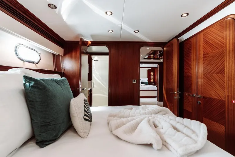 Slide: The Image of Luxurious bedroom interior of 2006 Hargrave Motor Yacht with wooden finishes and plush bedding. - 43