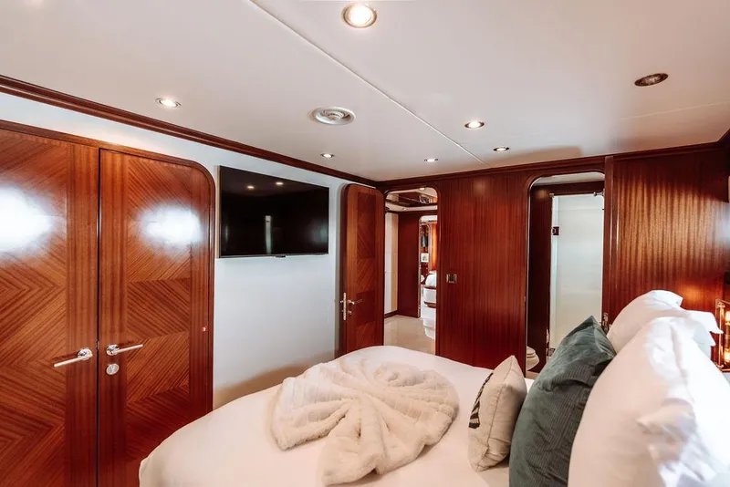 Slide: The Image of Luxurious bedroom interior of 2006 Hargrave Motor Yacht with wood paneling and modern amenities. - 46
