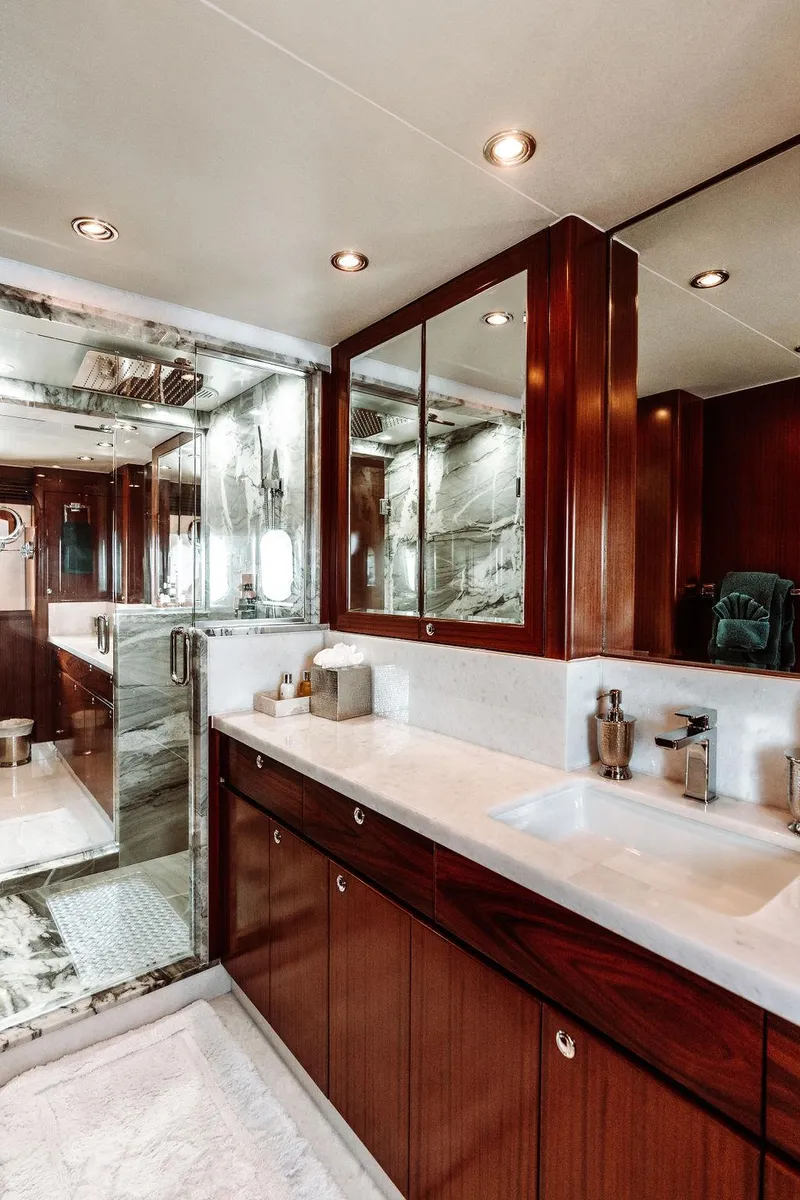 Slide: The Image of Luxurious bathroom in a 2006 Hargrave Motor Yacht with wooden cabinetry and marble accents. - 48