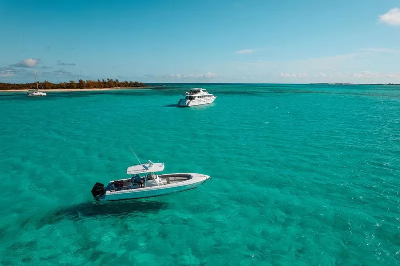 Slide: The Image of 2006 Hargrave Motor Yacht on turquoise waters with a smaller boat nearby - 6