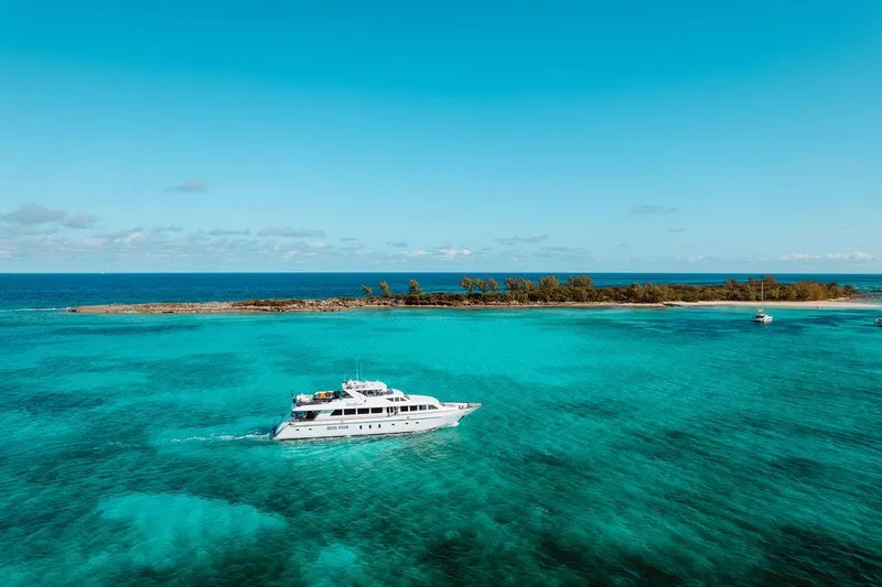 Slide: The Image of 2006 Hargrave Motor Yacht cruising in turquoise waters near a tropical island. - 8