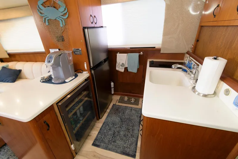 Slide: The Image of 1994 Ocean Yachts 44 Aft Cabin Motor Yacht kitchen with sink, fridge, and coffee maker. - 16