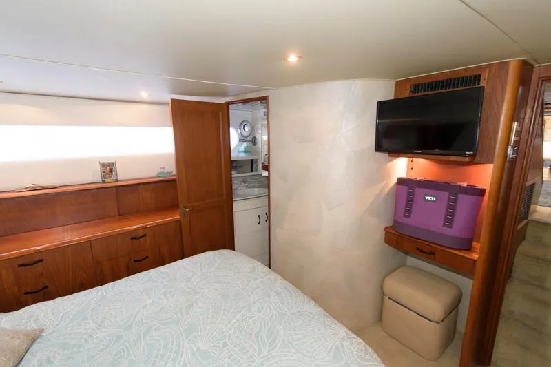 Slide: The Image of 1994 Ocean Yachts 44 Aft Cabin Motor Yacht bedroom with TV, storage, and ensuite bathroom. - 20