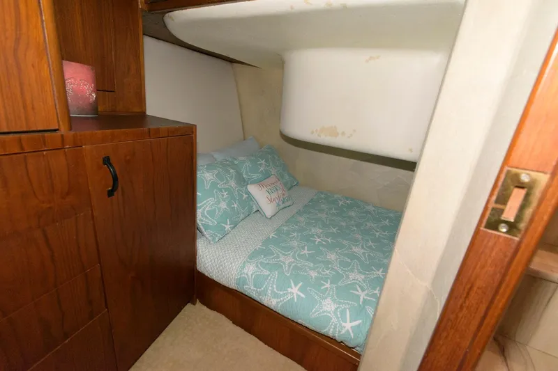 Slide: The Image of 1994 Ocean Yachts 44 Aft Cabin Motor Yacht cozy bedroom with starfish-themed bedding. - 23