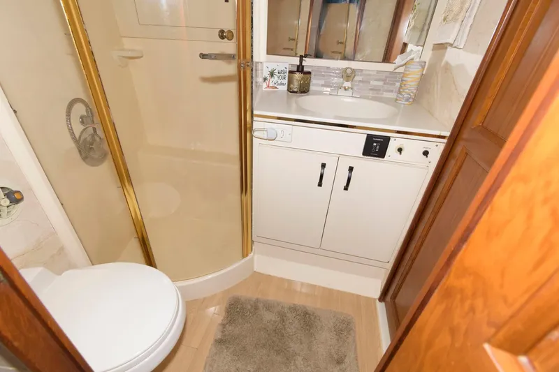 Slide: The Image of 1994 Ocean Yachts 44 Aft Cabin Motor Yacht bathroom with shower, sink, and toilet. - 24