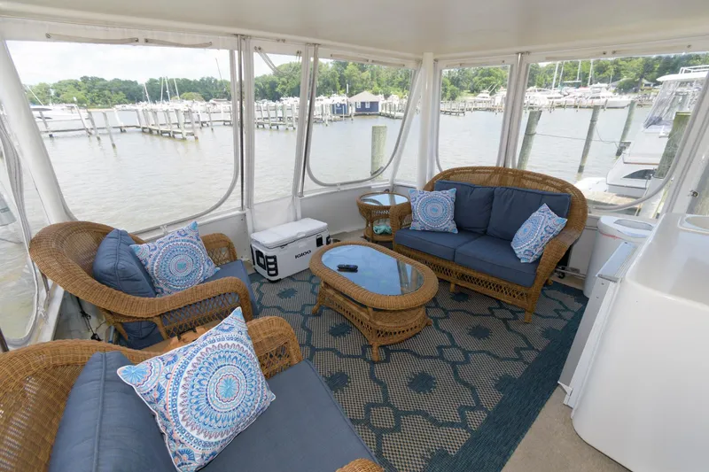 Slide: The Image of Spacious aft cabin of 1994 Ocean Yachts 44 Motor Yacht with wicker furniture and marina view. - 6