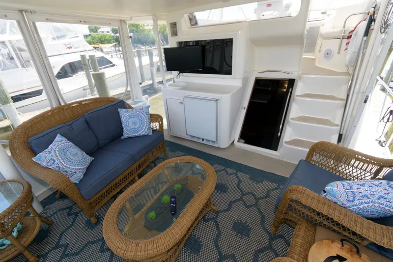 Slide: The Image of 1994 Ocean Yachts 44 Aft Cabin Motor Yacht interior with wicker furniture and TV. - 7