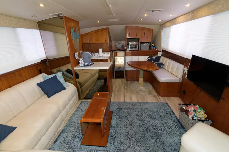 Slide: The Image of 1994 Ocean Yachts 44 Aft Cabin Motor Yacht interior with cozy seating and dining area. - 12