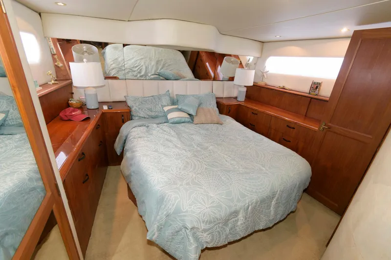 Slide: The Image of 1994 Ocean Yachts 44 Aft Cabin Motor Yacht bedroom with wooden cabinetry and a cozy bed. - 19