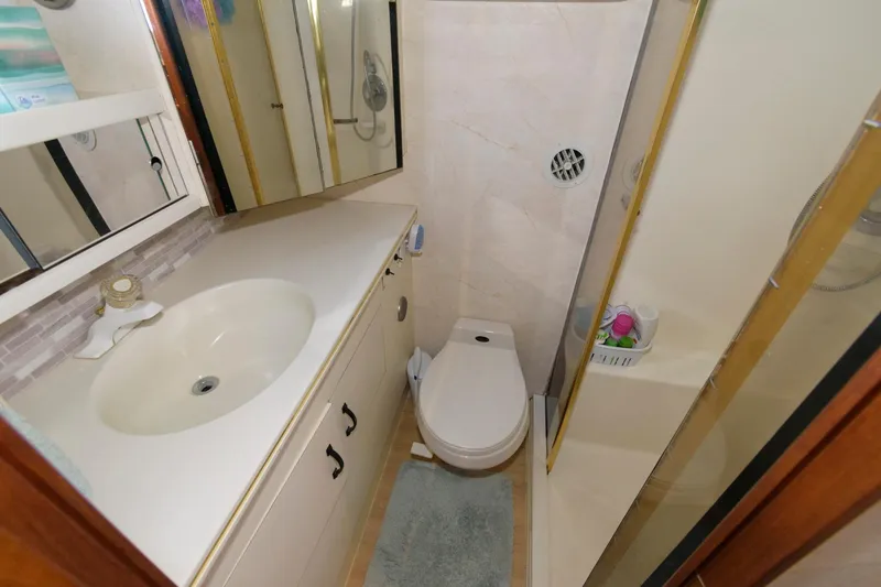 Slide: The Image of 1994 Ocean Yachts 44 Aft Cabin Motor Yacht bathroom with sink, toilet, and shower. - 21