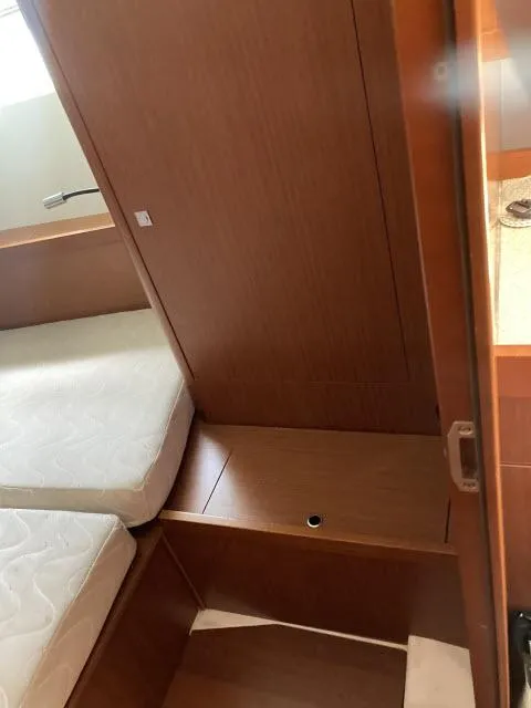 Slide: The Image of Interior cabin of 2014 Beneteau Oceanis 45 sailboat with wooden finish and mattress. - 20