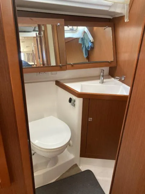 Slide: The Image of 2014 Beneteau Oceanis 45 bathroom with sink, mirror, and toilet. - 21