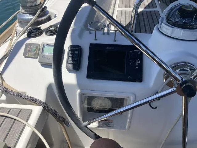 Slide: The Image of Cockpit of 2014 Beneteau Oceanis 45 sailboat with navigation instruments and steering wheel. - 25