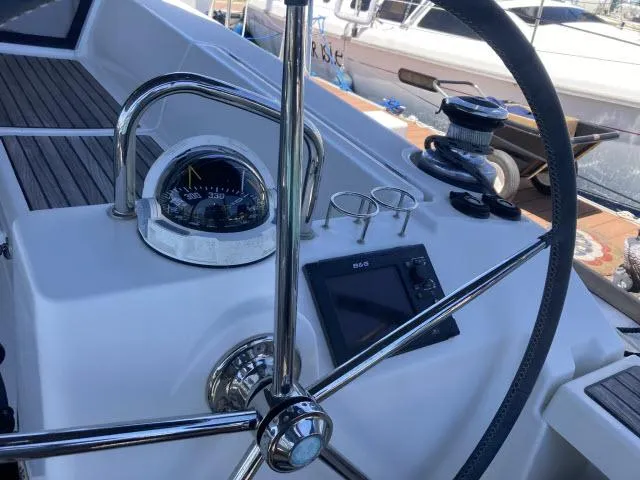 Slide: The Image of Beneteau Oceanis 45 2014 yacht helm with compass, navigation display, and winch. - 27