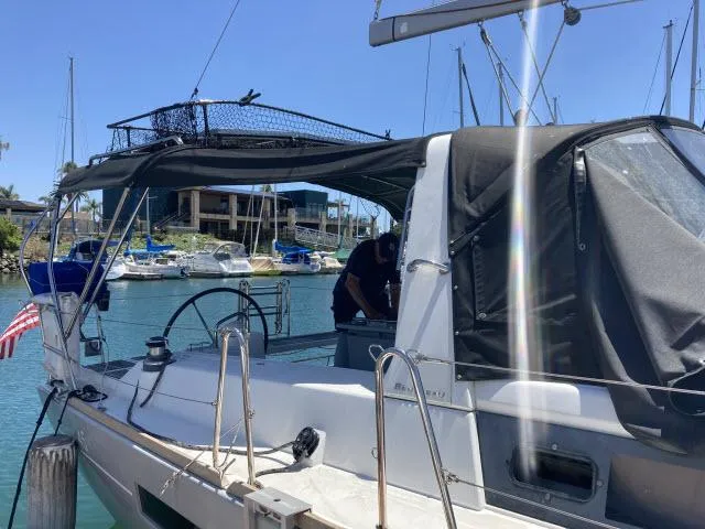 Slide: The Image of 2014 Beneteau Oceanis 45 sailboat docked in a marina with other boats. - 32