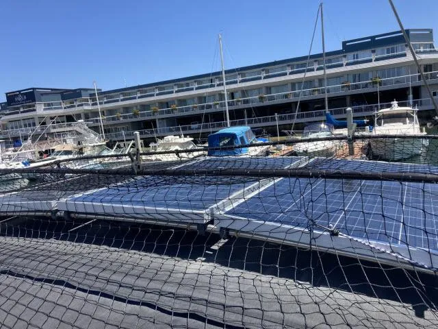 Slide: The Image of 2014 Beneteau Oceanis 45 sailboat docked at marina with solar panels. - 34